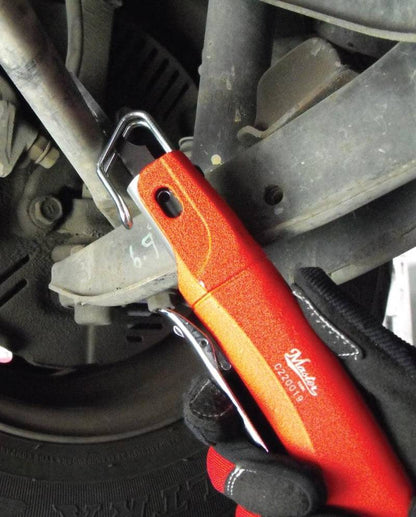 a red and orange tool sitting on top of a tire