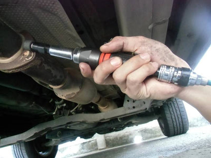 a man working on a vehicle with a wrench