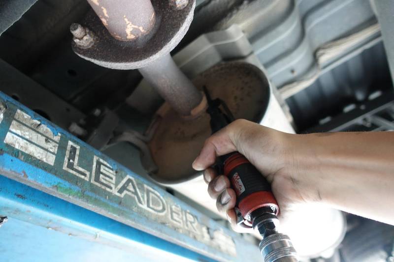 a person using a drill to fix a pipe