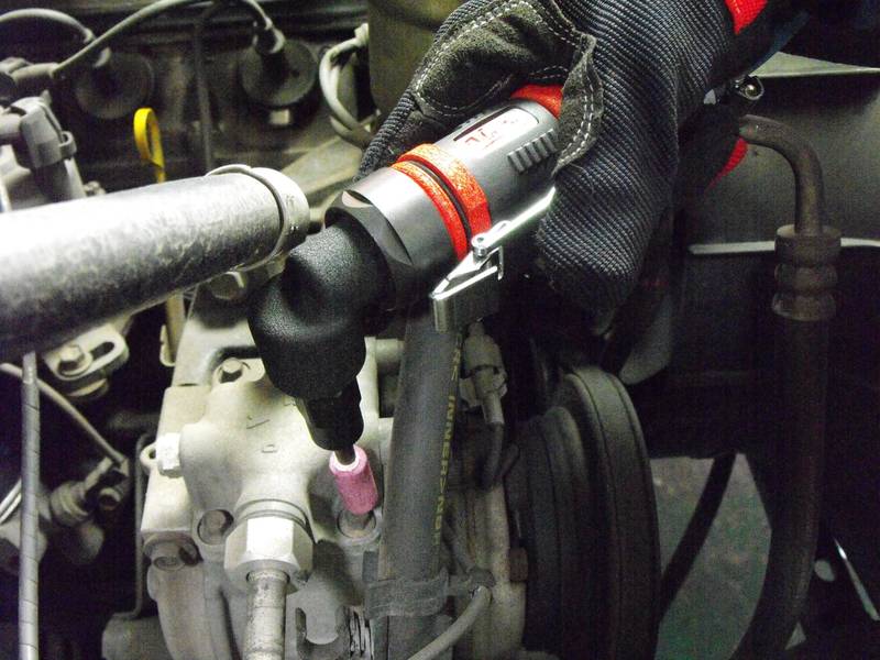 a close up of a person's glove on an engine